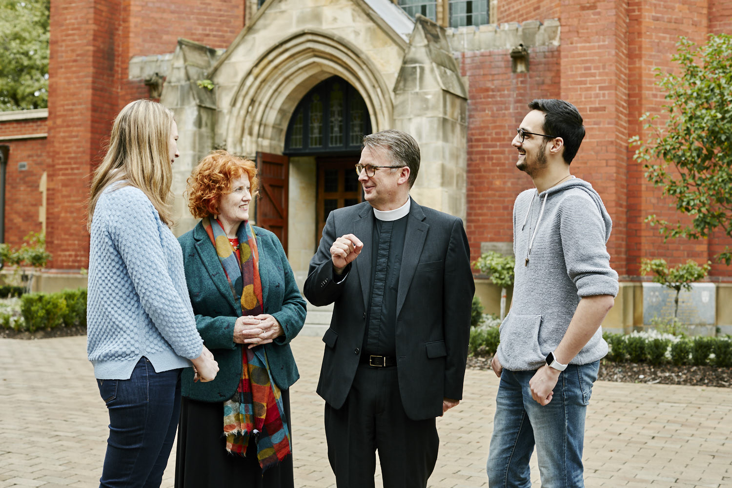 Students talking with Bob outside the Chapel