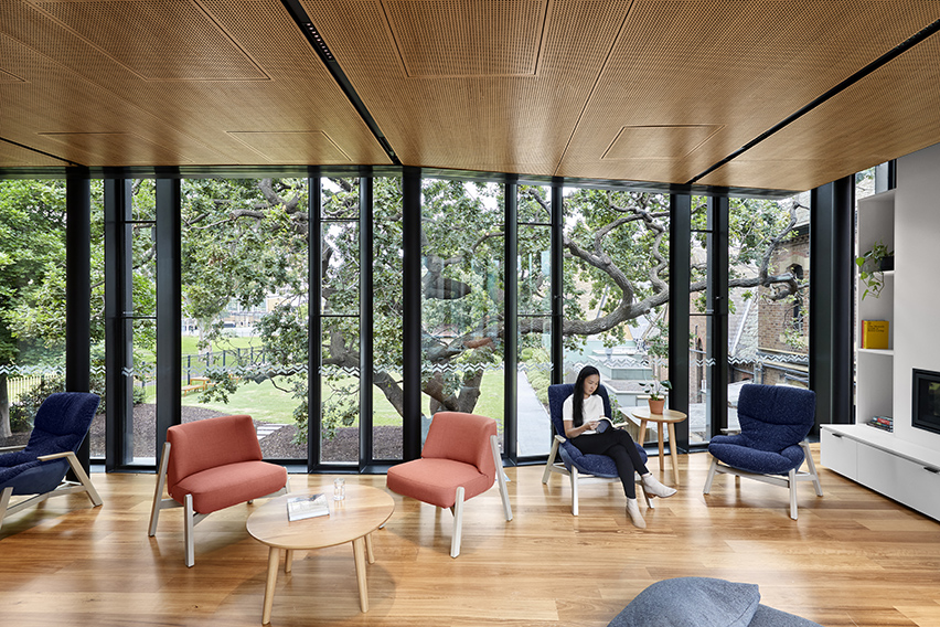 Image of girl sitting in our common rooms and reading a book